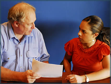 A Case Manager and Maria looking over a document