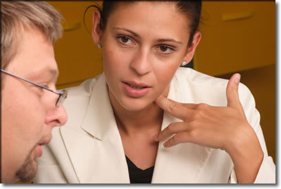 Photo of a woman conducting a crisis assessment on a man.