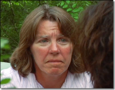 Still frame from video picturing a woman listening.