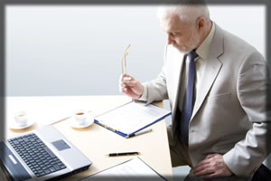 Man sitting working on documentation – folder and paper are present
