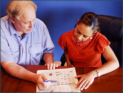 case manager helping Maria look through the paper