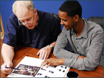 case manager and Hassan going looking over a book