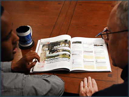 case manager and Hassan looking over a book