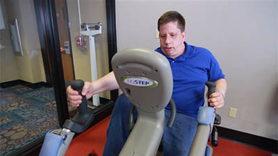 Person with IDD using an exercise bike at the YMCA