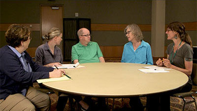 Photo of a support plan meeting with a nurse practitioner, caregiver, person with IDD, family member and case manager