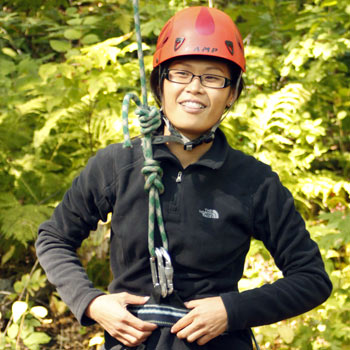 An active DeafBlind woman ready to do a little climbing