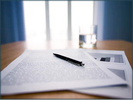 documents and a pen on a desk