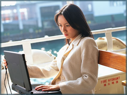 a business woman sitting infront of a computer