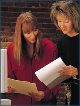 two business woman looking over papers