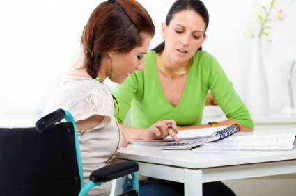 Woman in wheelchair discussing budgeting with another woman.